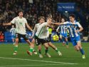 Castro, del Racing, y Charlie Patiño, del Deportivo, pugnan por un balón ante la mirada del racinguista Facu González (i)