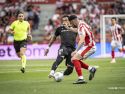 Pablo Vázquez, central del Sporting y autor de un gol, busca detener el avance de Miguel de la Fuente, jugador del Almería