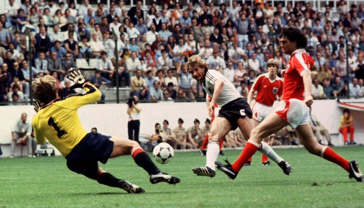 Wolfgang Dremmler dispara a la portería de Friedrich Koncilia en presencia de Bruno Pezzey durante el Alemania Federal-Austria del Mundial 82, el partido bautizado como ‘Desgracia de Gijón’