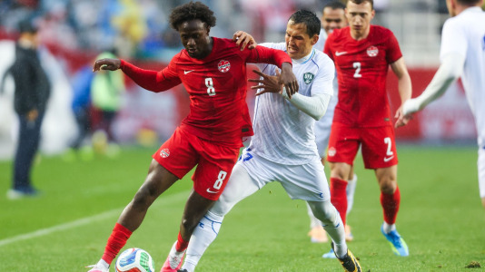 Canada's Ismael Kone (8) and Uzbekistan's Otabek Shukurov (7) vie for the ball during the first half of an international men's soccer friendly in Edmonton on Monday, June 1, 2026. THE CANADIAN PRESS/Codie McLachlan